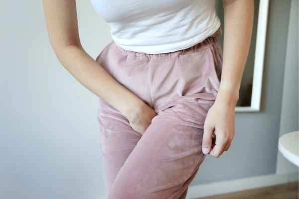 woman running for the toilet because of urinary incontinence Wrexham